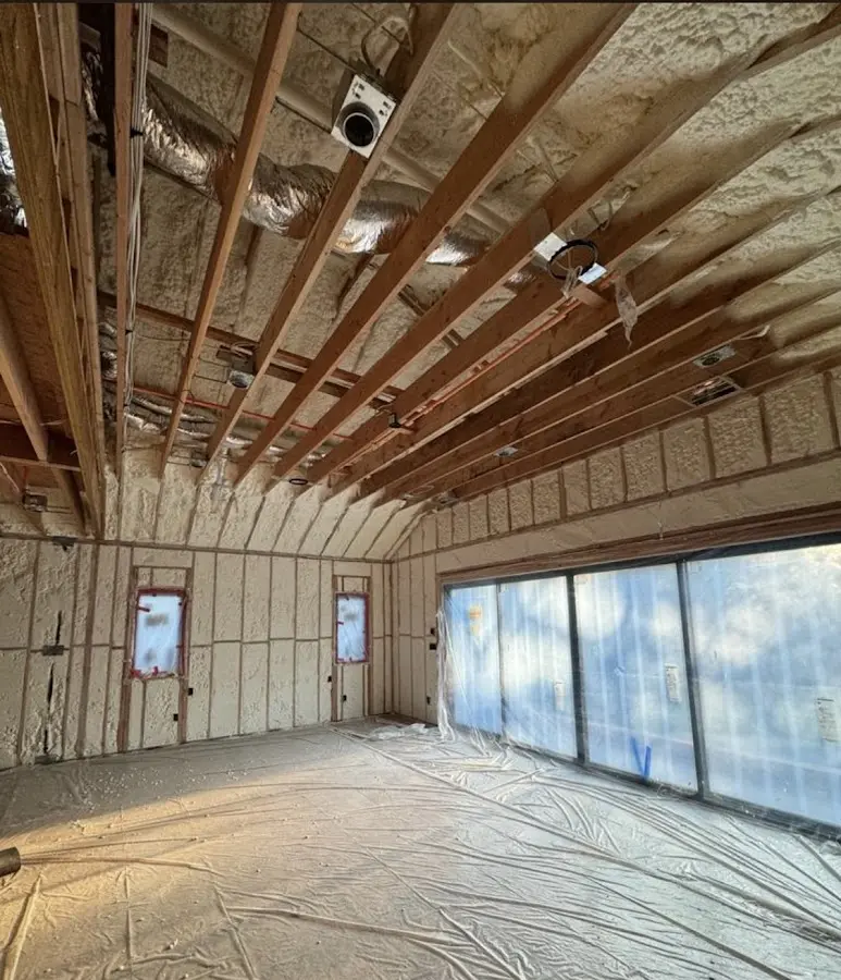 Interior walls and ceiling insulated with spray foam during new construction in Valley Stream